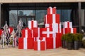 A pile of red big gift boxes in front of modern architecture