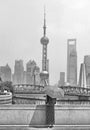 Shanghai pudong modern skyline with girl with umbrella, China