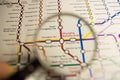 Shanghai Railway Station metro station on a printed paris metro map under a magnifier lens