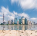 Shanghai skyline in afternoon and reflection with wooden floor Royalty Free Stock Photo