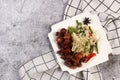 Shanghai-Style Red Braised Pork Belly or Hong Shao Rou and vegetable rice on a white square plate on a dark background
