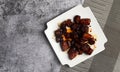 Shanghai-Style Red Braised Pork Belly or Hong Shao Rou on a white square plate on a dark background