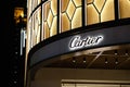 Close up shop sign of Cartier at night
