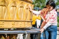 Chinese tourist woman posing with the Giant Tibetan Buddhist prayer wheel of Dafo temple in Shangri-La Yunnan China