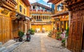 Old wooden Tibetan houses and dramatic light in the street of Dukezong ancient town Shangri-La Yunnan China