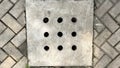 The shape of the concrete drain cover with holes on the heringbone motif conblock floor