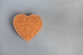 Shape heart of buckwheat grain on the gray background closeup taken with copy space at right