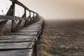 Shape of a pier near a lake, wintertime on a foggy morning, in Sic illage, nsylnia, Romania Royalty Free Stock Photo