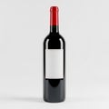 Tall Dark Red Wine Bottle With Red Cap And Blank White Label On White Background Royalty Free Stock Photo