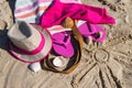 Shape of sun and accessories for relax on sand. Straw hat, slippers and towel. Vacation time on beach