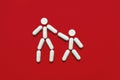 The shape of two little men from tablets on a red background, the concept of treatment and protection against disease Royalty Free Stock Photo