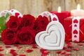 Shape of white heart in front of bouquet of red roses Royalty Free Stock Photo