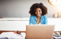 Shape your own future independently. an attractive young woman working on her laptop at home.