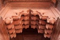 Exterior detail of Agra Fort - shaped arch adorned with carved details in red sandstone in Agra, Uttar Pradesh, India Royalty Free Stock Photo