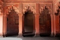 Shaped archs adorned with carved details in red sandstone - exterior detail of Jahangiri Mahal in Agra Fort, India Royalty Free Stock Photo