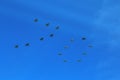 70 shaped formation of a group of fifteen russian military fighter jet planes flying high in blue sky during Vicotry Day parade