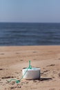 A shaped piece of styrofoam on the sand at the beach