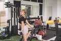 A shapely asian woman doing a standing quad stretch. Warming up before a workout at the gym Royalty Free Stock Photo