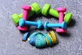 Dumbbells made of pink, green and cyan plastic
