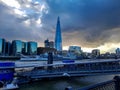 The shard in London city at river thames view sunset clouds boat ferry at pier transport winter day skyline maritime uk