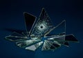 Shards of broken mirror glass are scattered on a dark surface. The pieces vary in size Royalty Free Stock Photo