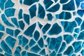 Shards of glass stuck on a surface with grout. Royalty Free Stock Photo