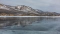 Shards of ice lie on the frozen lake.