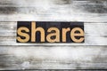 Share Letterpress Word on Wooden Background