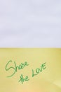Share the love handwriting text close up isolated on yellow paper with copy space