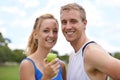 They share a passion for healthy living. A couple couple smiling while standing on a sportsfield. Royalty Free Stock Photo
