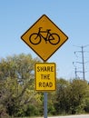 Share the road with bicycles sign natural setting Royalty Free Stock Photo