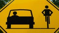 Share the road traffic sign. Black car and bicycle rider on yellow background Royalty Free Stock Photo