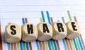 SHARE word on wooden round blocks with colorful bar chart background Royalty Free Stock Photo