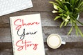 Share your story concept on notebook with cup of coffee and keyboard, lilies flowers Royalty Free Stock Photo