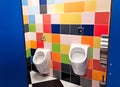 Shared family bright restroom with two pisuars in shopping center, mall. Unisex WC for man, dad, boy, child kid. Use