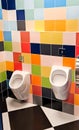 Shared family bright restroom with two pisuars in shopping center, mall. Unisex WC for man, dad, boy, child kid. Use