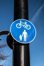 Shared pedestrian and cycle route circular sign on a black pole