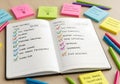 Shared to-do list notebook with colorful checkmarks and teamwork tools around it, symbol of productivity, planning, and successful Royalty Free Stock Photo