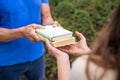 Sharing Books. Hand Closeup Giving Book