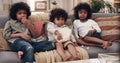 Sharing is caring. three adorable little boys eating popcorn and watching movies together at home. Royalty Free Stock Photo