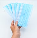 Sharing disposable surgical masks or blue colored new medical masks. COVID-19 prevention. H1N1, H5N1 safetymeasures..