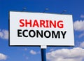 Sharing economy symbol. Concept words Sharing economy on beautiful white billboard. Beautiful blue sky white cloud background. Royalty Free Stock Photo