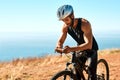 Sharing the experience with his online friends. a male cyclist out for a ride on his mountain bike.