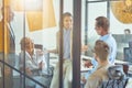 Sharing fresh ideas. Young mixed race female office worker discussing something with colleagues while having a meeting Royalty Free Stock Photo