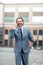 Cheerful businessman calling wife while sharing good news