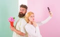 Sharing happy selfie. Woman capturing happy moment boyfriend bring bouquet flowers. Capturing moment to memorize. Taking Royalty Free Stock Photo