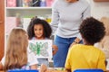 Sharing her artwork with the class. a preschooler showing the class her artwork.