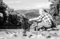 Sharing his secrets. Experienced fisherman show tips to son. Beautiful evening riverside. Men riverside catching fish Royalty Free Stock Photo