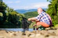 Sharing his secrets. Experienced fisherman show tips to son. Beautiful evening riverside. Men riverside catching fish Royalty Free Stock Photo