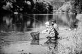 Sharing his secrets. Experienced fisherman show tips to son. Transferring knowledge. Men riverside catching fish Royalty Free Stock Photo